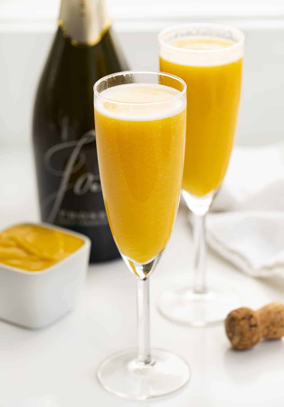 Two Champagne Glasses of Peach Bellini Cocktail.