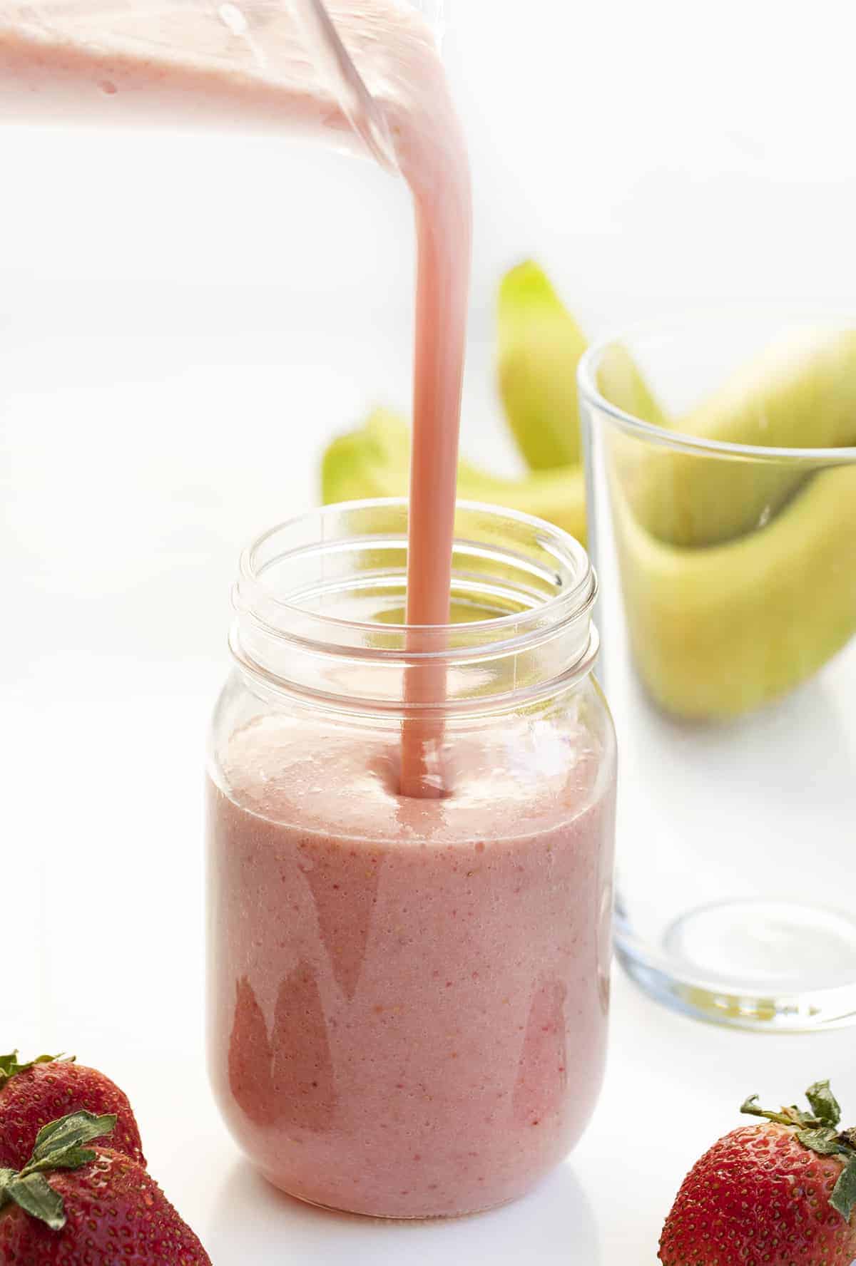 Pouring Strawberry Banana Smoothie into Mug