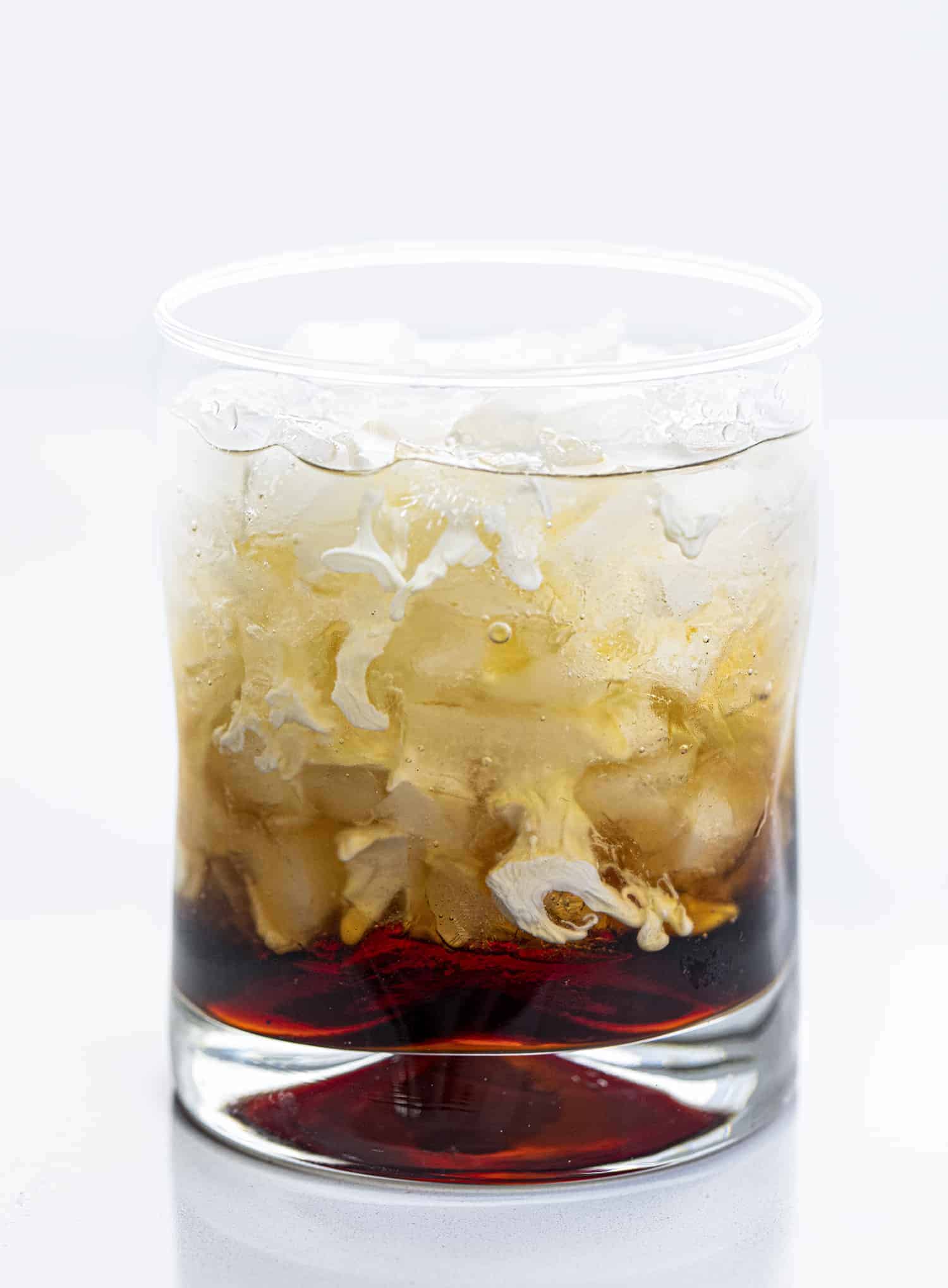 Ingredients for White Russian in Cocktail Glass unstirred