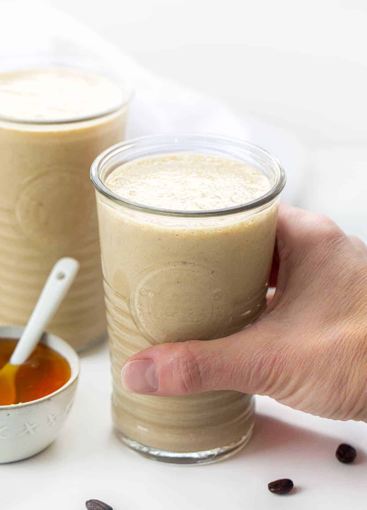 Hand Picking up a Glass Filled with Coffee Breakfast Smoothie - Good Morning Smoothie.