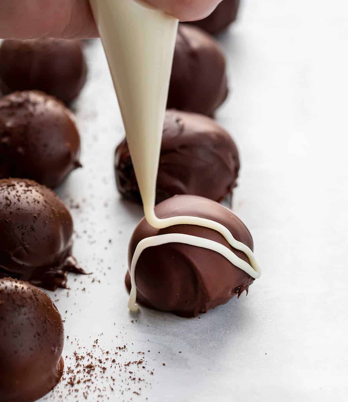 Drizzling Oreo Balls with Melted Chocolate