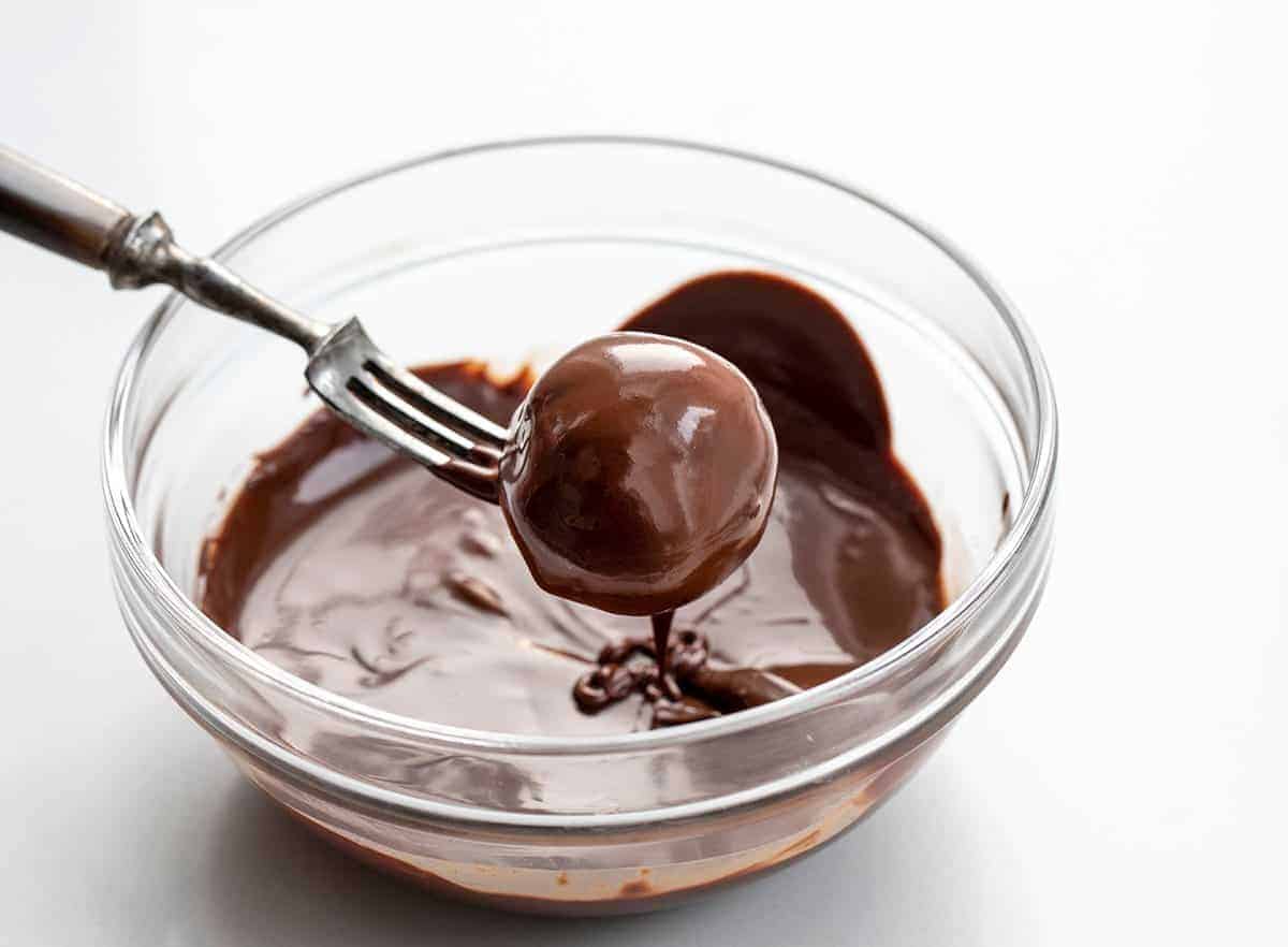 Dipping Oreo Balls into Melted Chocolate