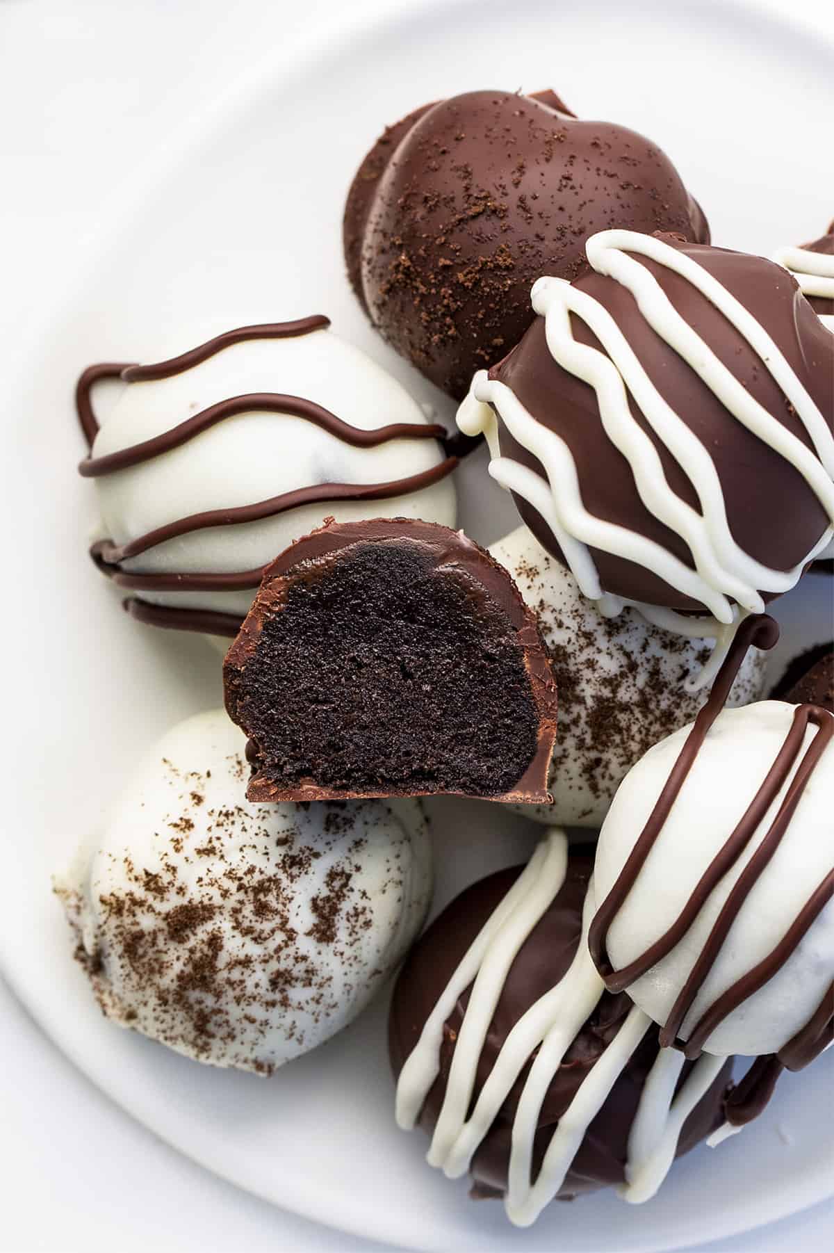 Plate of Easy Oreo Truffles with Dark and White Chocolate and One Cut in Half