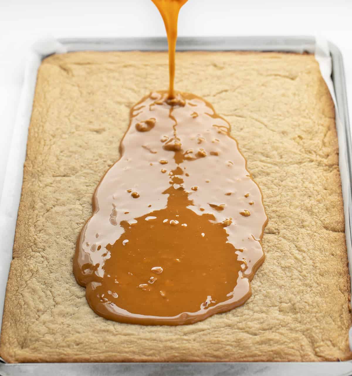Pouring Sauce over Peanut Butter Bars