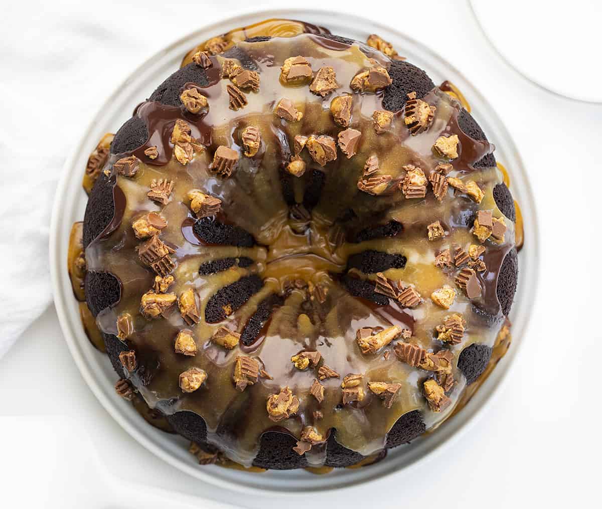 Chocolate Peanut Butter Bundt Cake on White Cake Plate From Overhead