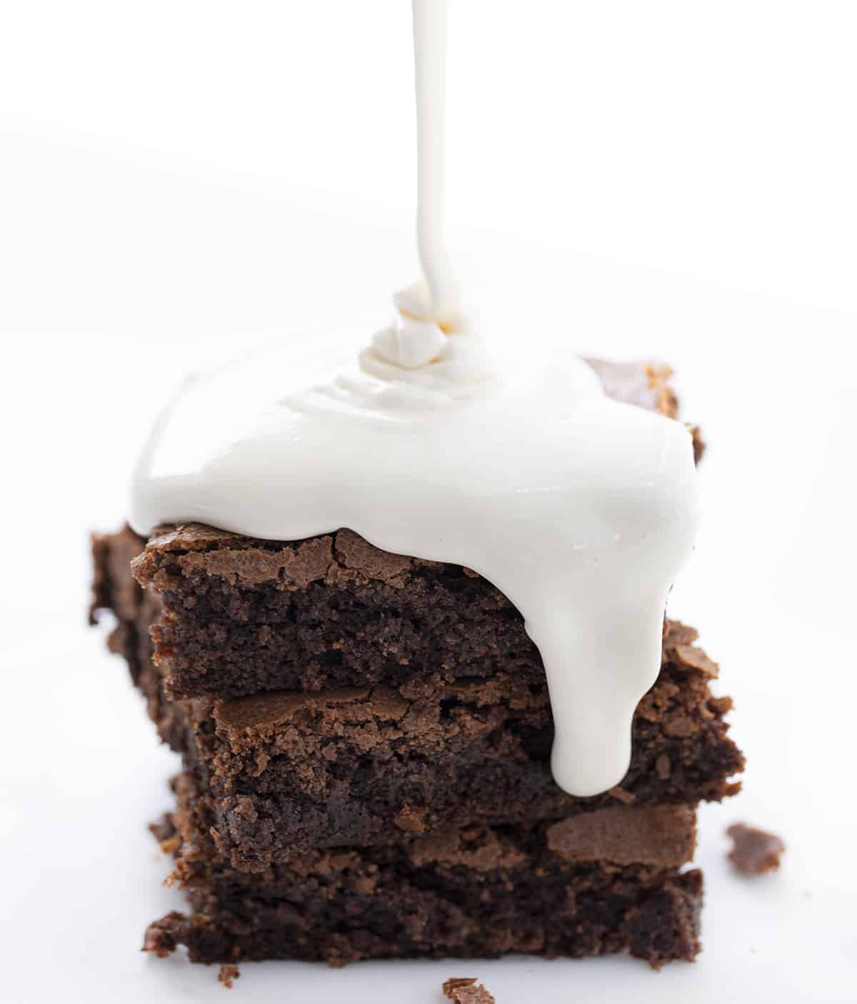 Pouring Mallow Sauce over Brownies