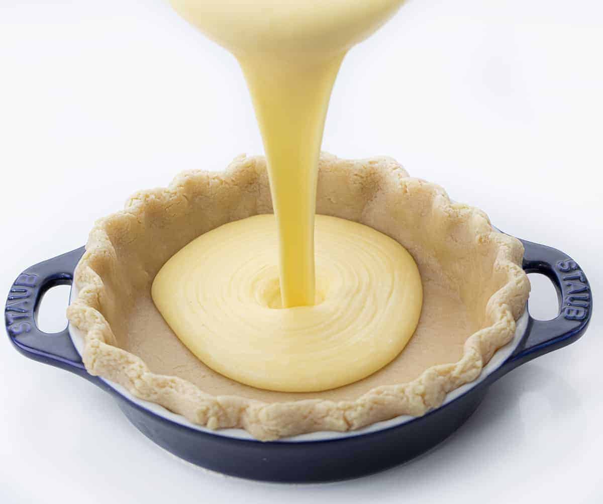Pouring Batter Into Pie Crust for Chess Pie Recipe