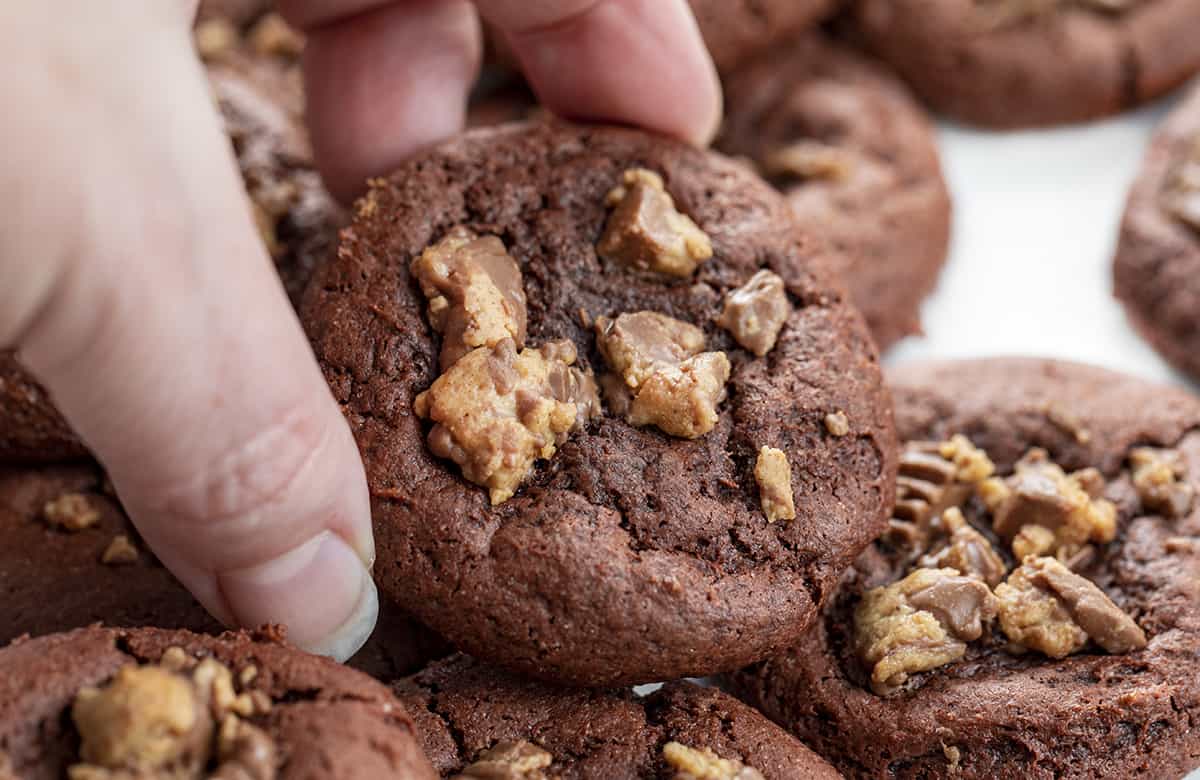 Hand Picking up a Reese's Cake Mix Cookies.