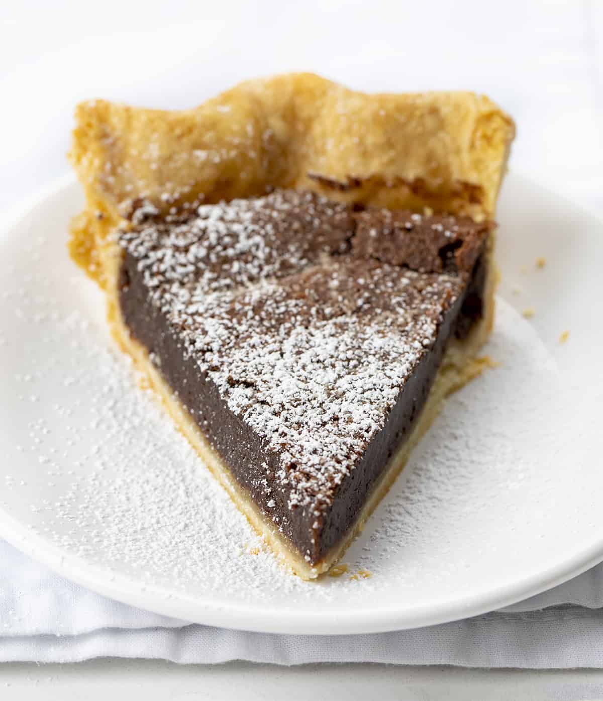 One Piece of Chocolate Cheese Pie on a White Plate