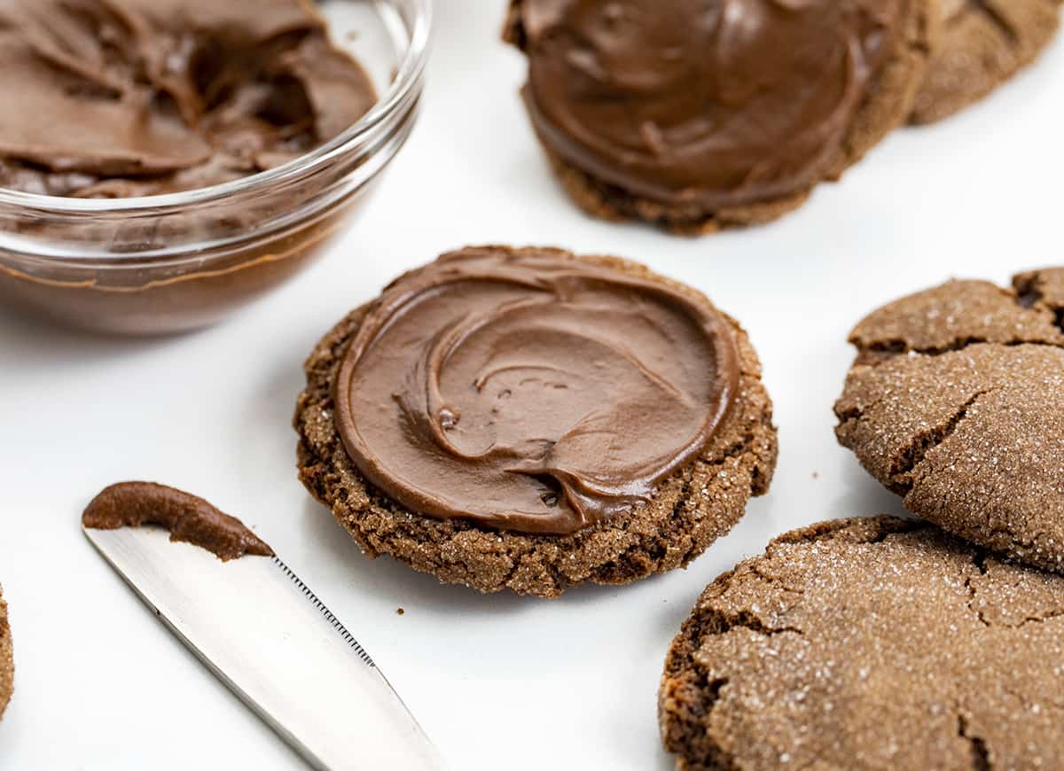 Spreading Chocolate Frosting on a Chocolate Cookie.