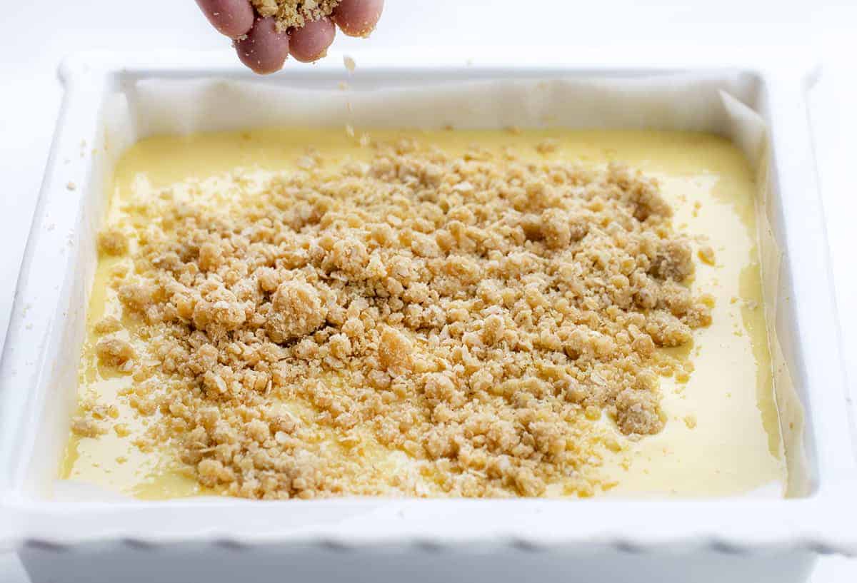 Sprinkling Crumb onto Lemon Crumb Bars