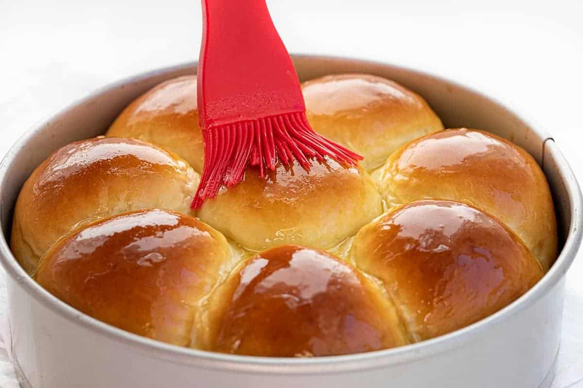 Adding Butter to Baked Japanese Milk Bread Rolls