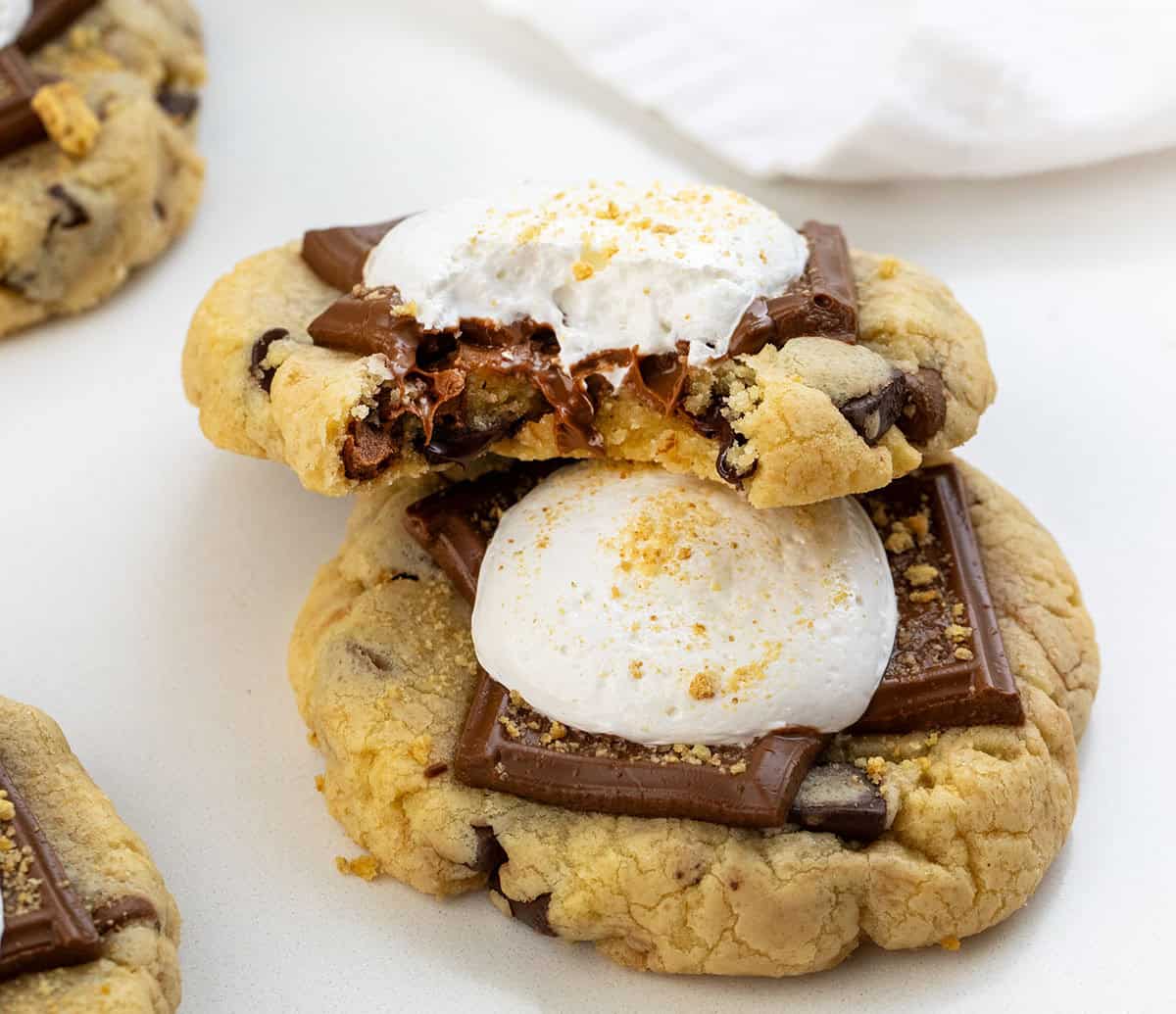 Close up of S'mores Cookies with one cookie bit into showing inside texture.