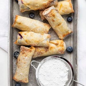 Blueberry Cheesecake Egg Rolls in a Pan from Overhead and Dusted with Confectioners Sugar. Dessert Egg Rolls, Dessert, Egg Rolls, Egg Roll Recipes, Blueberry Cheesecake, Cheesecake, Snacks, Dessert Appetizer, Hot Dessert, Blueberry Desserts, Summer Desserts, How to Make Cheesecake Egg Rolls, Recipes, i am baker, iambaker