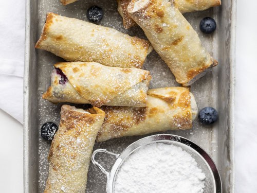 Close-up of creamy cheesecake filling in crispy egg roll wrapper