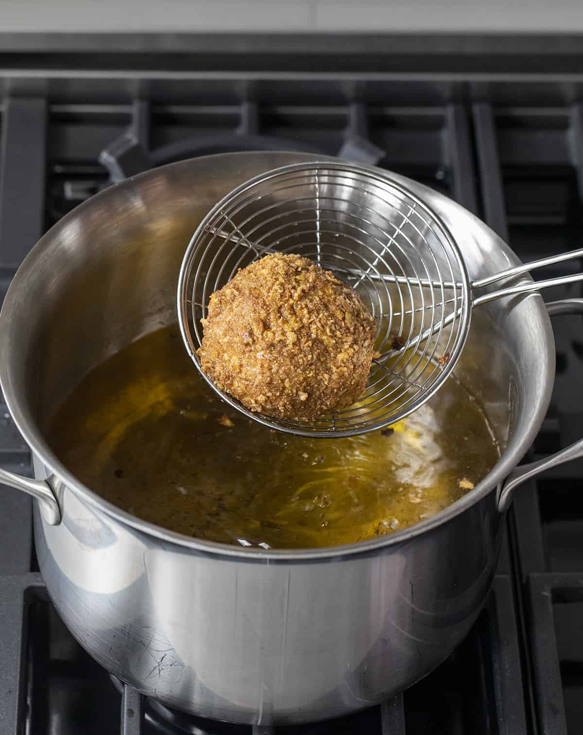 Dipping Fried Ice Cream into Hot Oil and then Removing It.