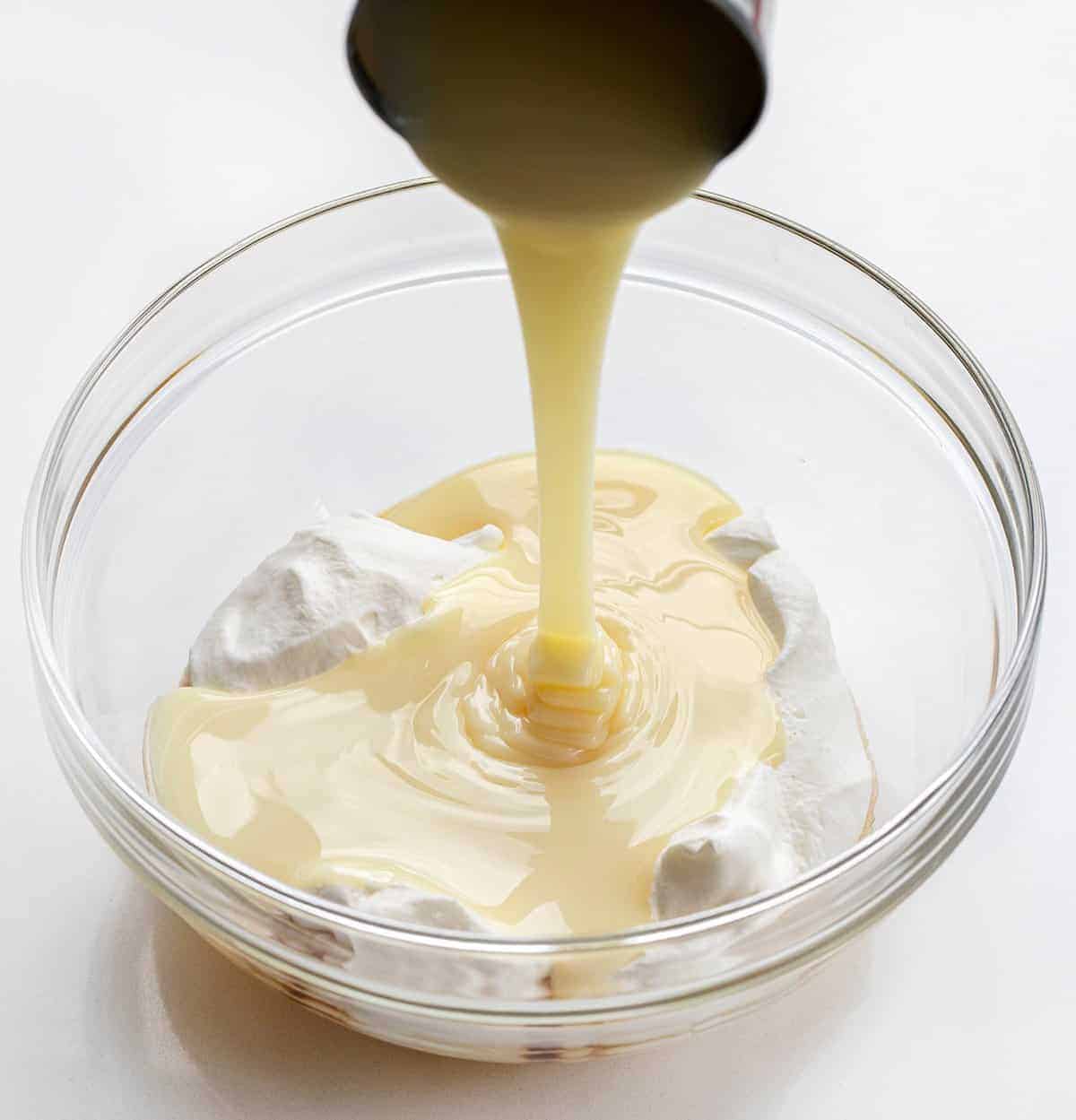 Pouring Sweetened Condensed Milk into Bowl for No Churn Ice Cream Recipe - 4 Ingredient Ice Cream