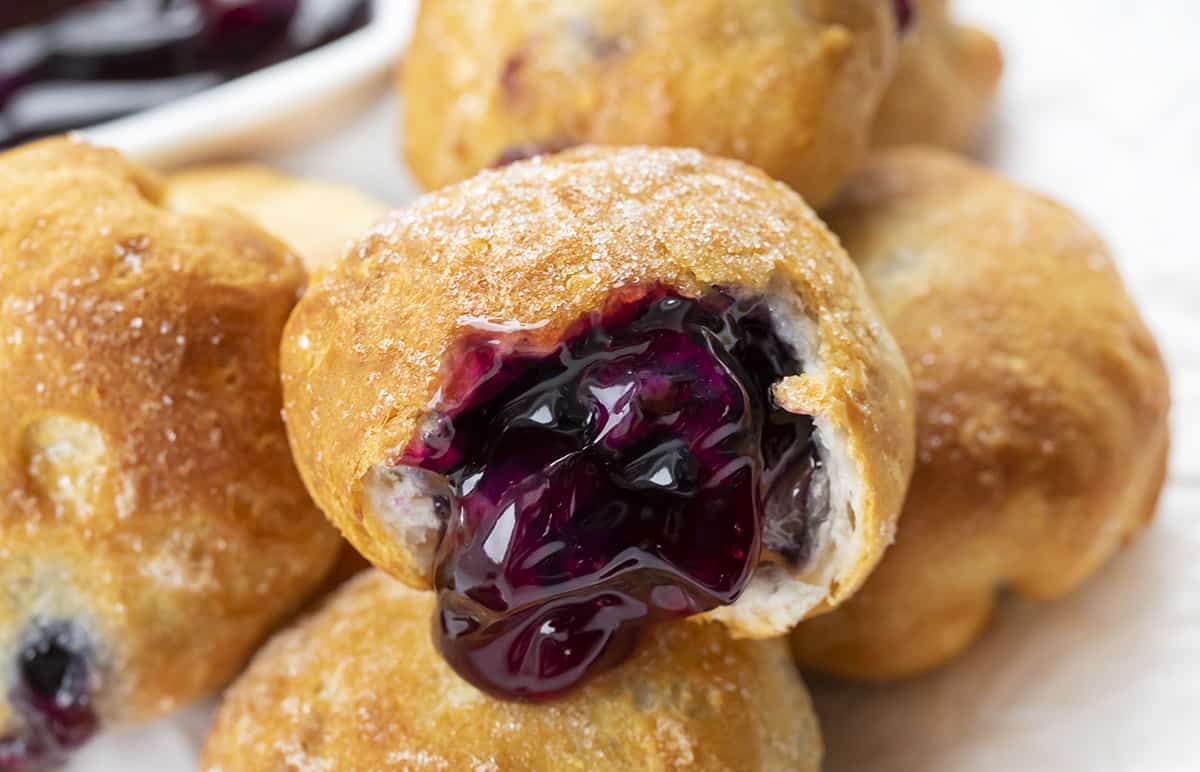 Close up of a Blueberry Pie Bomb. Breakfast, Blueberry Pie Bombs, Fruit Filled Hand Pies, Air Fryer Recipes, Blueberry Breakfast, Baked Blueberry Desserts, Dessert, Cherry Pie Bombs, Baked Pie Bombs, recipes, i am baker, iambaker