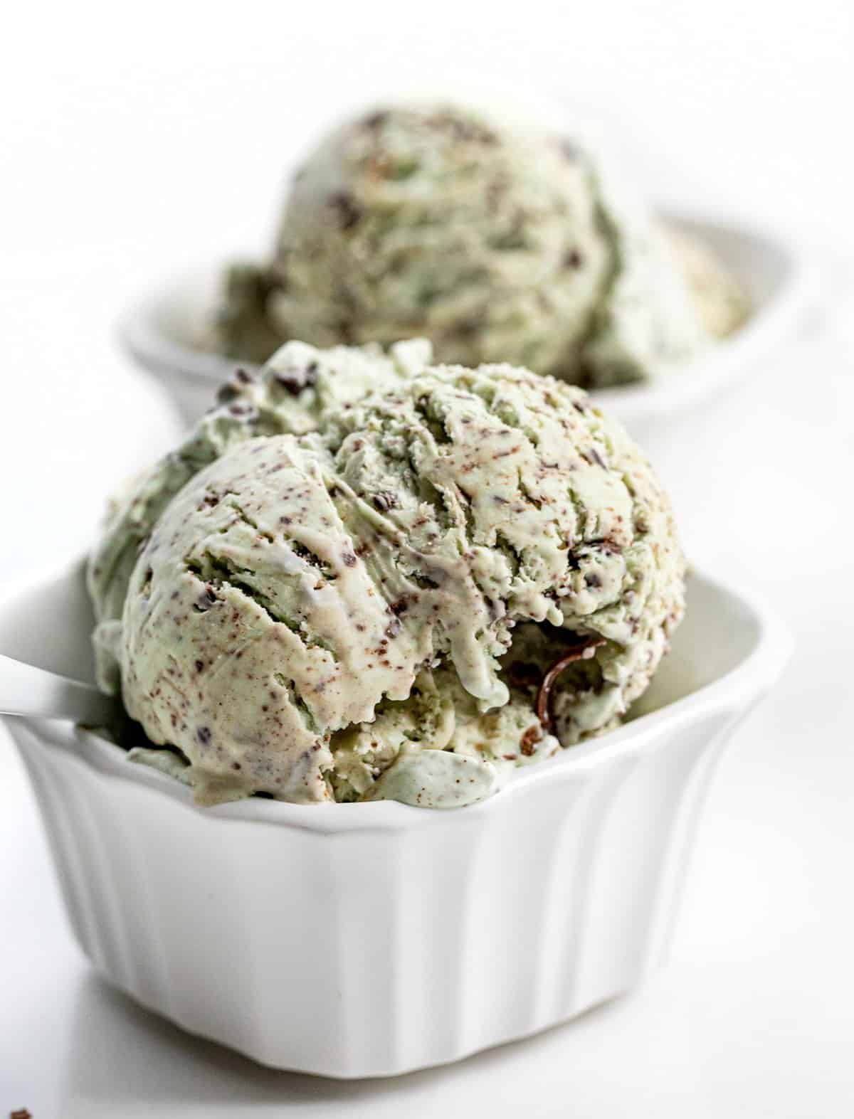 Two Bowls No-Churn Mint Chocolate Chip Ice Cream Loaded Full on a White Counter
