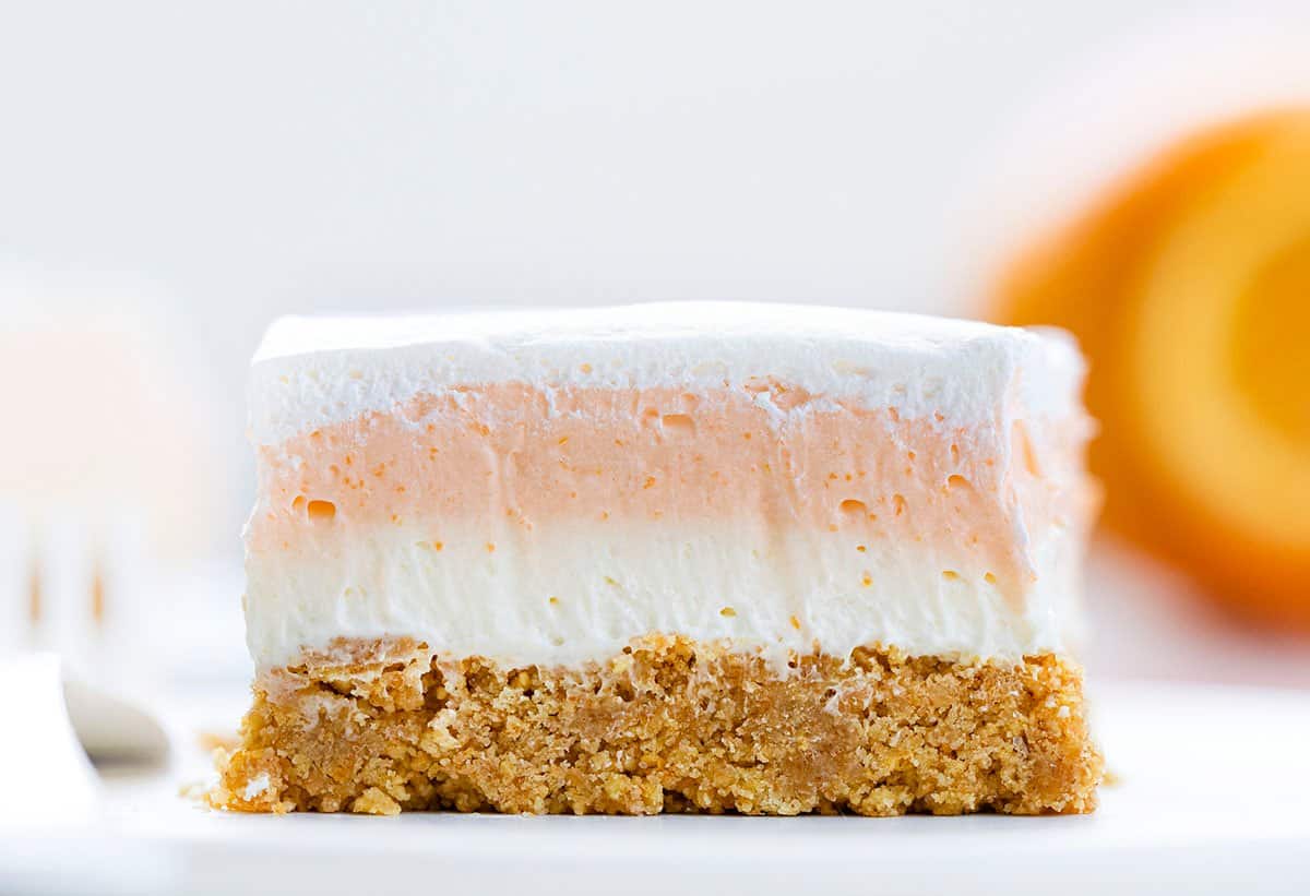 One Piece of Orange Creamsicle Bars on a White Plate