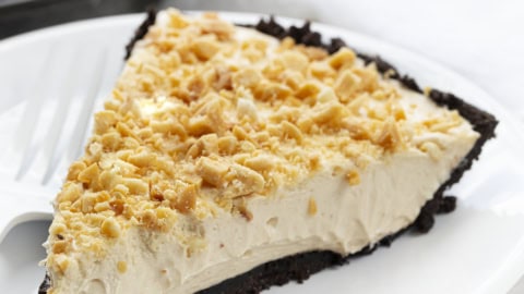 Piece of Easy Peanut Butter Pie on a White Plate with White Fork.