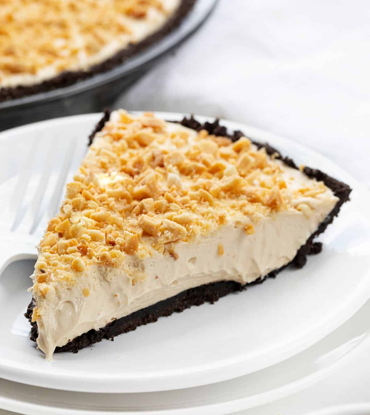 Piece of Easy Peanut Butter Pie on a White Plate with White Fork. 