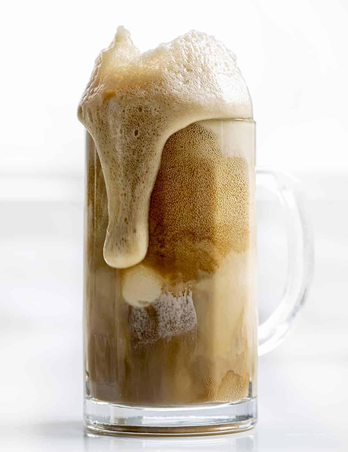 Soda Spilling Over the Mug for a Root Beer Float.