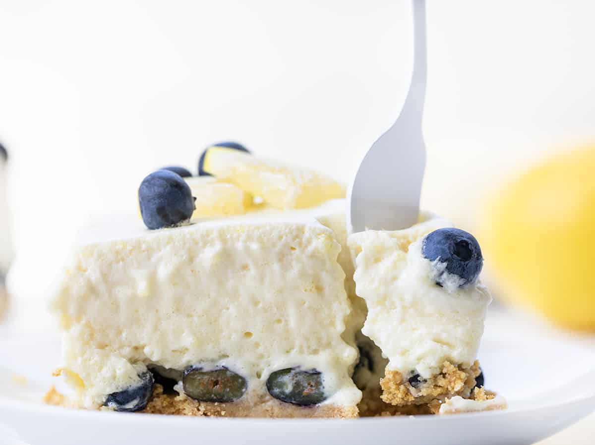 Plate with One Piece of Blueberry Icebox Cake on a White Plate with A Bite Being Removed.