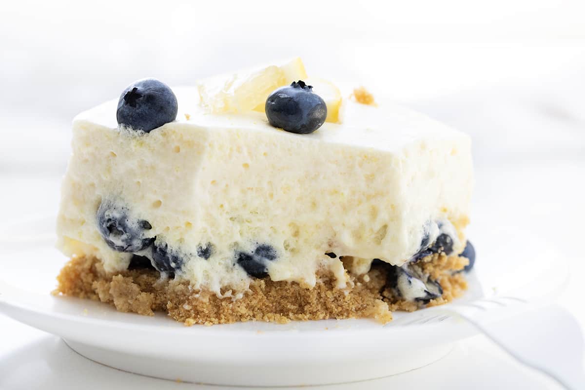 Plate with One Piece of Blueberry Icebox Cake on a White Plate With a Bite Removed.