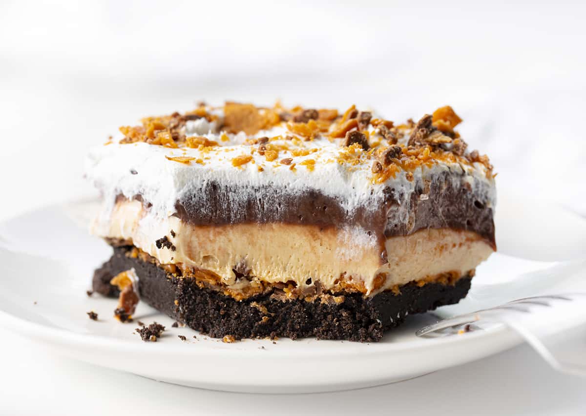 Piece of Butterfinger Lush with a Bite Removed. Dessert, No Bake Dessert, Butterfinger Desserts, Layered Desserts, Lush, Lush Desserts, dessert recipes, i am baker, iambaker