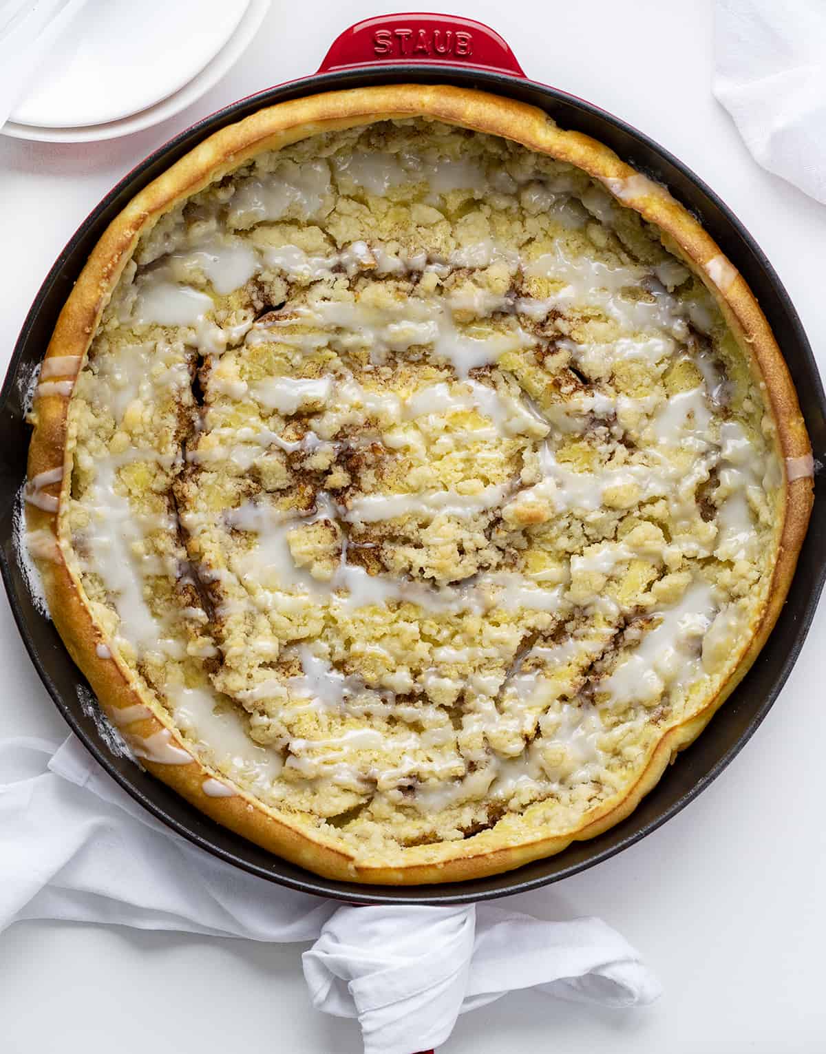 Overhead Image of Cinnamon Sugar Dutch Baby in Skillet on White Counter. Breakfast, Dutch Baby, How to Make Dutch Baby, Easy Breakfast, breakfast recipes, breakfast for guests, i am baker, iambaker.