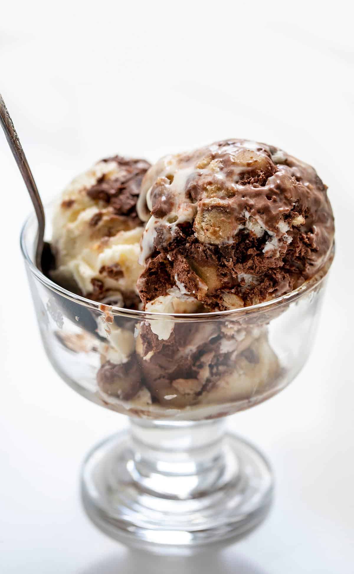 Scoops of Cookie Dough Brownie Ice Cream in a Glass Bowl.
