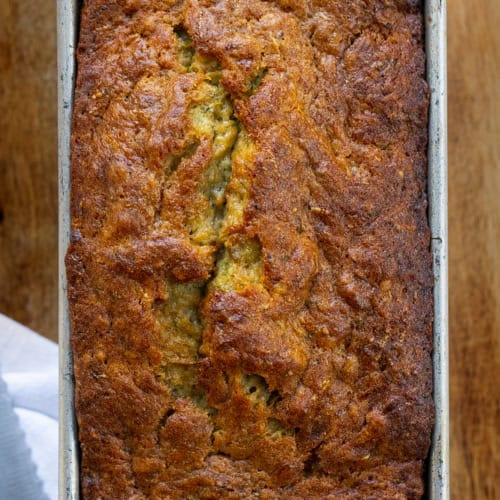 Loaf of Banana Zucchini Bread in Pan on Wood Cutting Board. Quick Bread, Banana Bread, Zucchini Bread, Baking, Zucchini Recipes, How to Bake with Zucchini, Easy Bread Recipe, Easy Zucchini Bread, Dessert, Snack, i am baker, iambaker