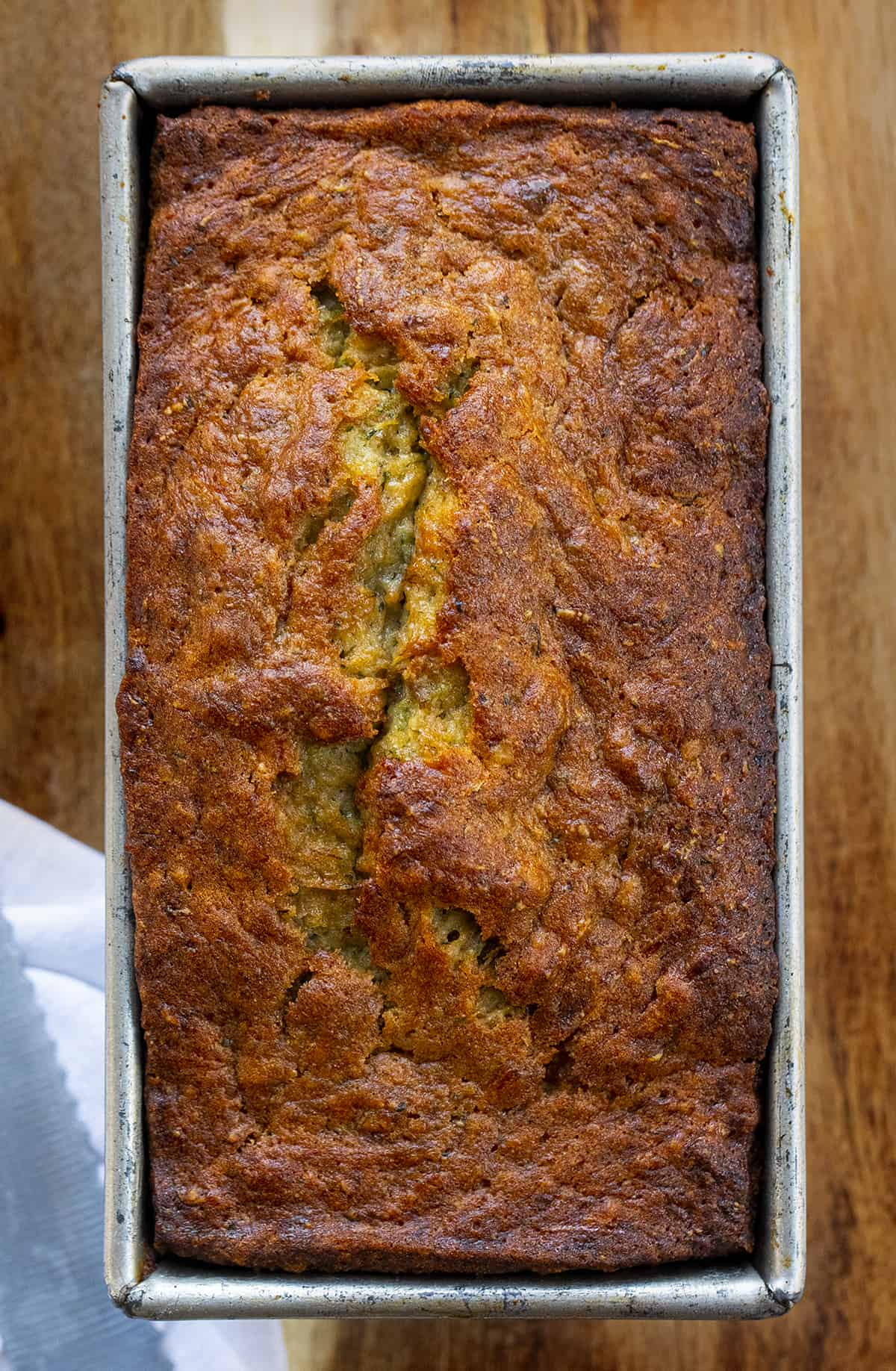 Loaf of Banana Zucchini Bread in Pan on Wood Cutting Board. Quick Bread, Banana Bread, Zucchini Bread, Baking, Zucchini Recipes, How to Bake with Zucchini, Easy Bread Recipe, Easy Zucchini Bread, Dessert, Snack, i am baker, iambaker