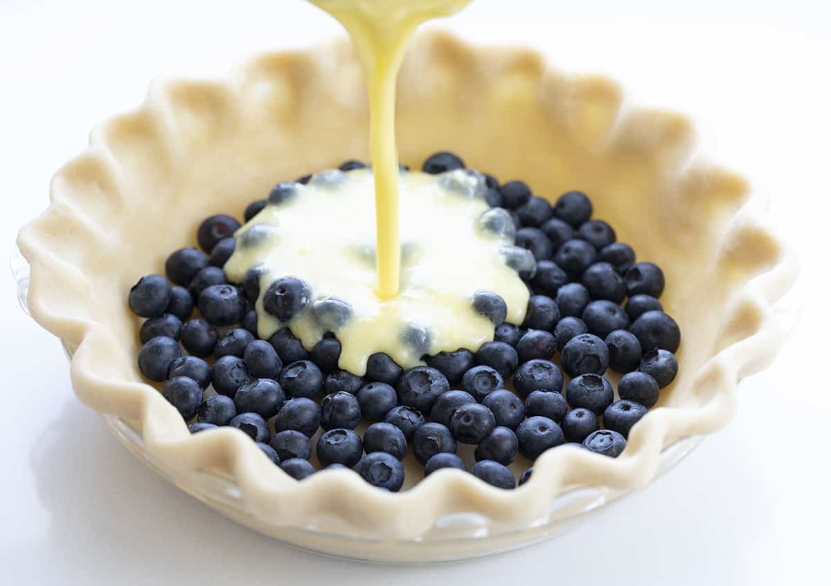 Adding Buttermilk to Pie Crust with Fresh Blueberries in it. Dessert, Baking, Pie, Pie Crust, Best Pie Crust, Buttermilk Pie, Blueberry Pie, Christmas Dessert, Summer Dessert, Old Fashioned Dessert, i am baker, iambaker