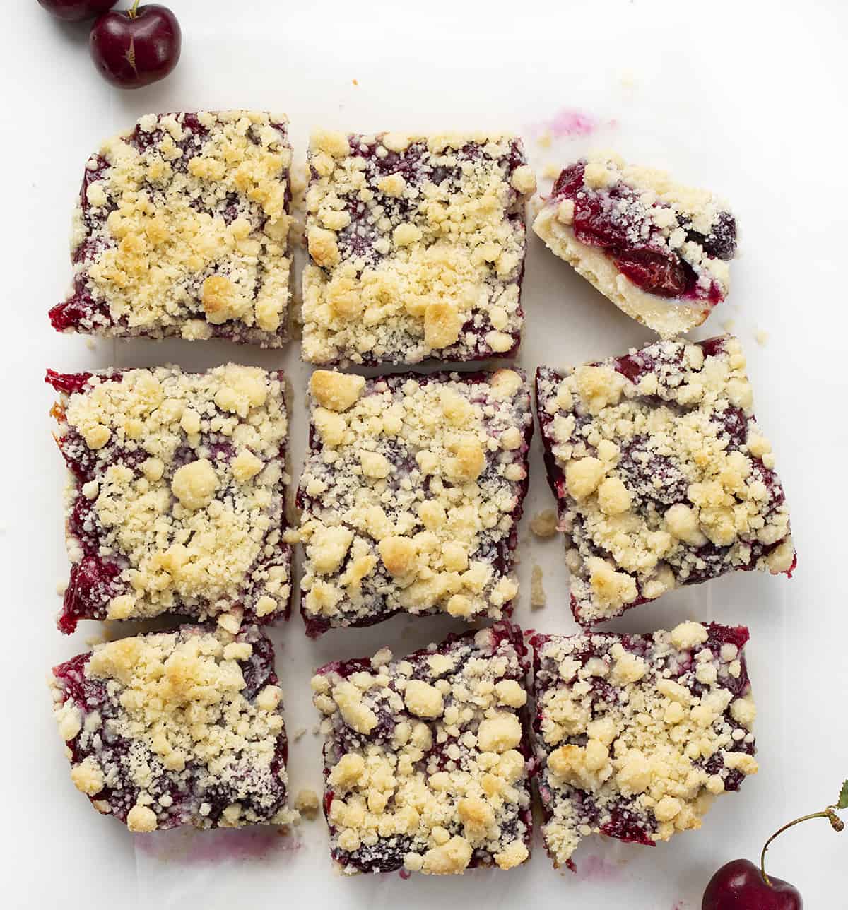 Overhead Image of Cut Up Cherry Pie Bars with One on Its Side. Dessert, Baking, Bars, Cherry Bars, Cherry Pie Bars, Homemade Cherry Pie Filling, Easy Bars, Real Cherry Desserts, Summer Baking, Winter Baking, Christmas Recipes, i am baker, iambaker.