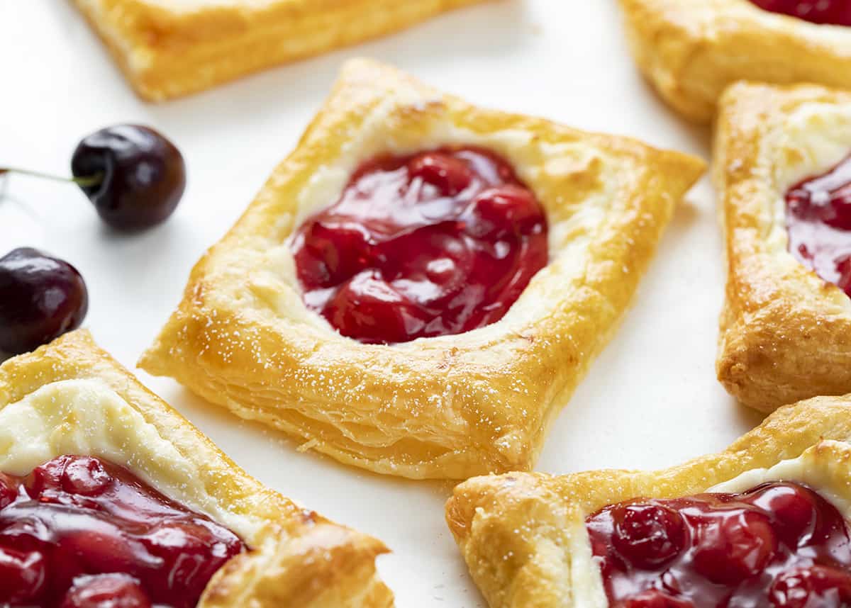 Cherry Danish on a Counter with Fresh Cherries. Breakfast, Cherry, Cherry Cream Cheese Danish, Easy Breakfast Danish, Puff Pastry, Puff Pastry Danish, Quick Breakfast Recipes, Hot Breakfast, i am baker, iambaker