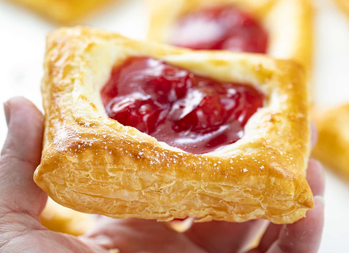 Hand Holding a Cherry Danish Showing the Thick Edge. Breakfast, Cherry, Cherry Cream Cheese Danish, Easy Breakfast Danish, Puff Pastry, Puff Pastry Danish, Quick Breakfast Recipes, Hot Breakfast, i am baker, iambaker