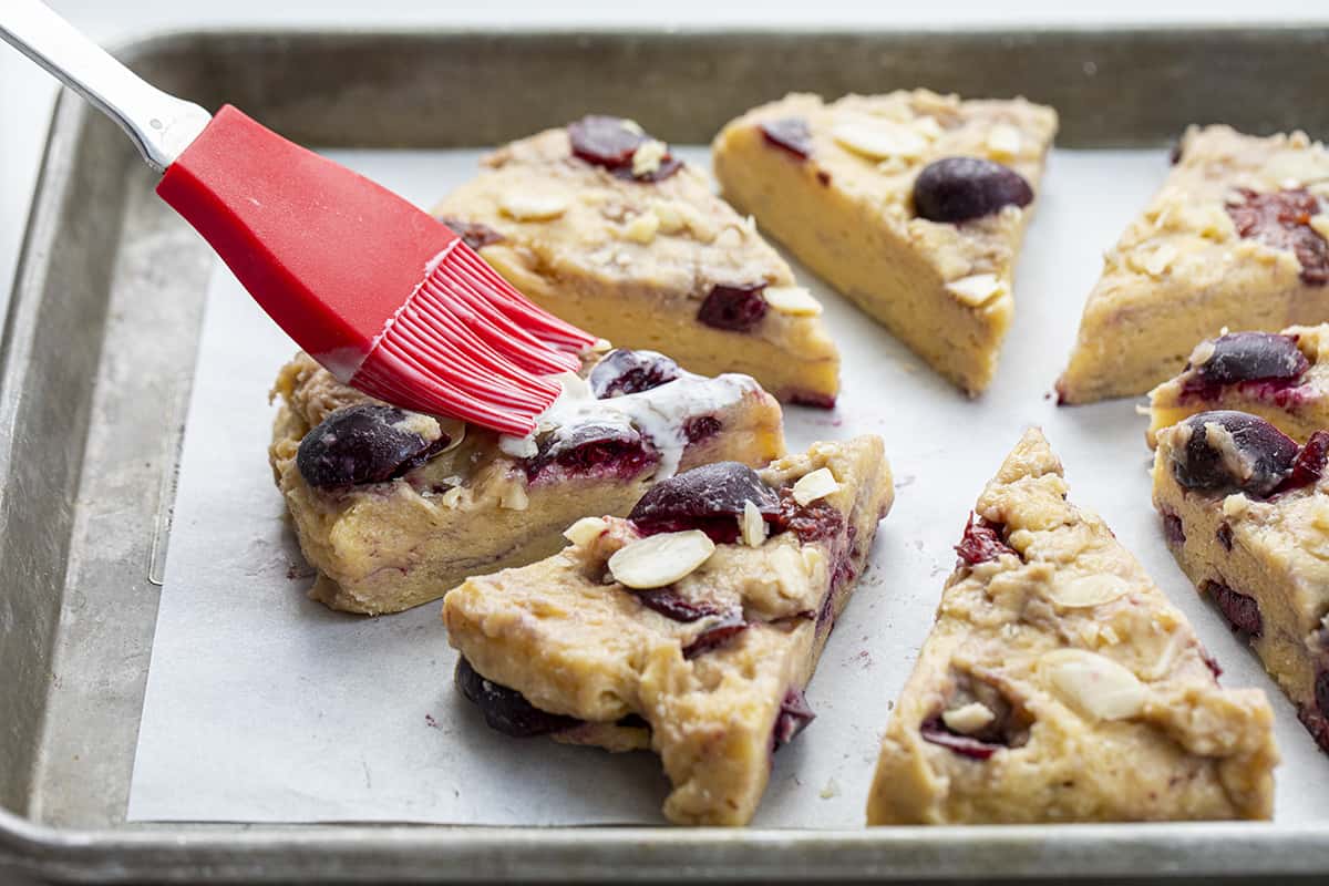 Brushing Heavy Cream over Raw Cherry Almond Scones. Breakfast, Scones, Scones Recipes, Cherry Scones, How to Make Scones, Breakfast Recipes, Cherry Recipes, iambaker, i am baker