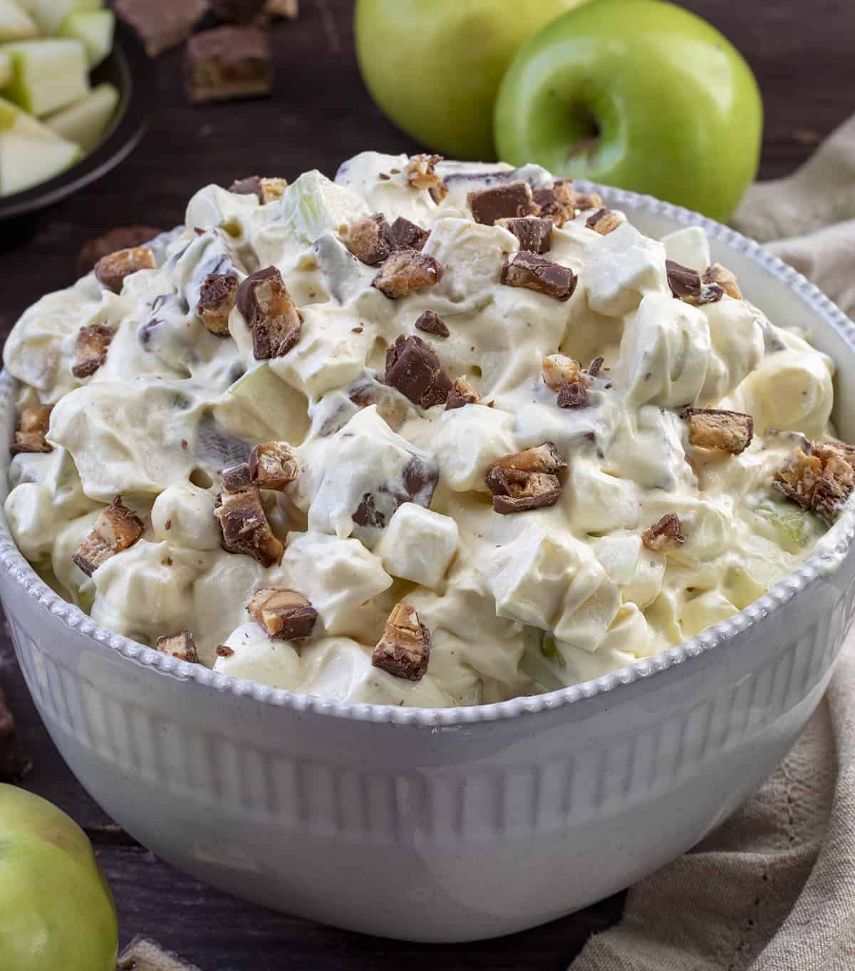 Bowl of Snickers Candy Salad with Apples Around It. Dessert, Summer Salads, Midwestern Salad, Candy Apple Salad, Fluff Salads, Whipped Cream Salads, BBQ Salad, i am baker, iambaker