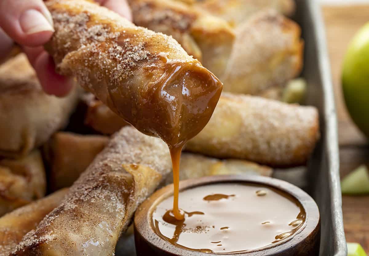 Apple Pie Egg Roll Dipped into Caramel Sauce. Dessert Egg Rolls, Apple Egg Rolls, Apple Pie Egg Rolls, Easy Apple Pie Recipes, Dessert, Air Fryer Apple Pie Egg Rolls, Oven Apple Pie Egg Rolls, Super Bowl Desserts, Thanksgiving Desserts, Christmas Desserts, Snacks, i am baker, iambaker