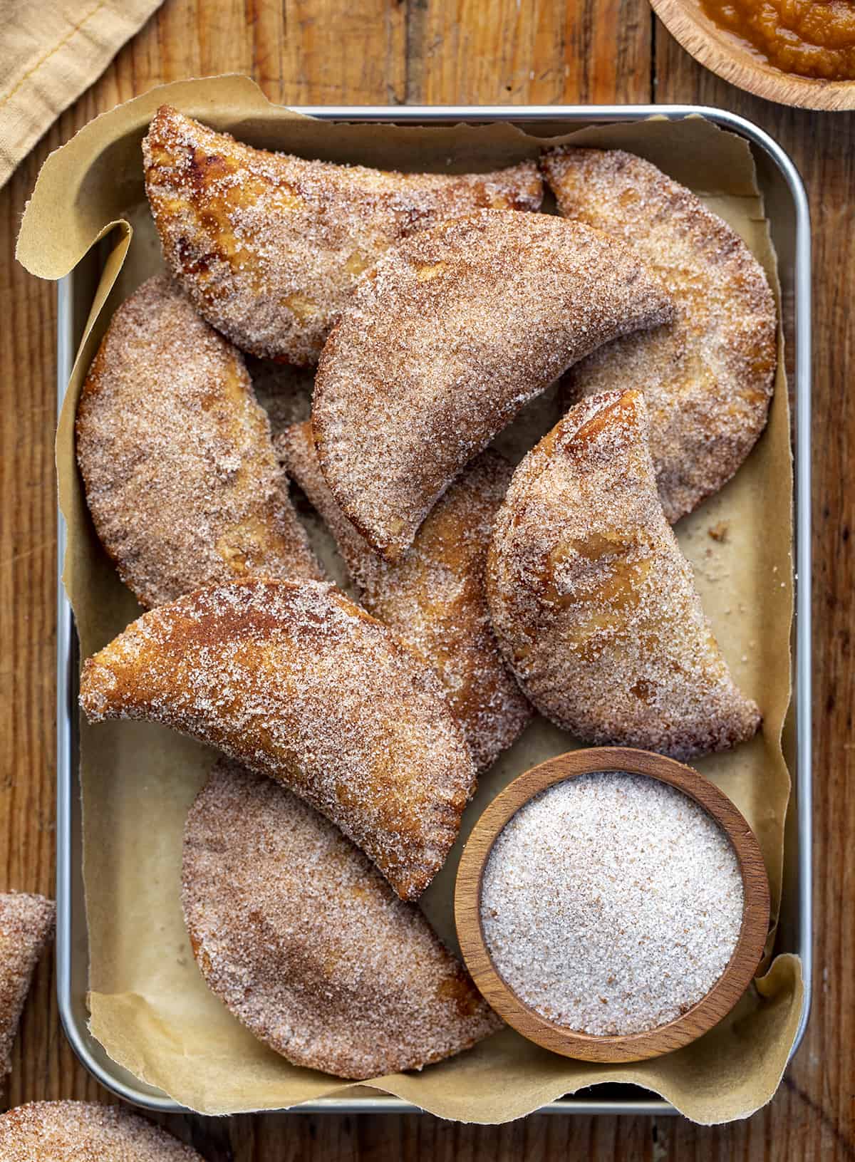 Pumpkin Hand Pies in a Pan from Overhead. Pumpkin Hand Pies, Pumpkin Bombs, Pumpkin Desserts, Pumpkin Snacks, Pumpkin Spice, Pumpkin Crisps, Fried Pumpkin Pies, Individual Pumpkin Pies, Cinnamon Sugar Pumpkin Pies, fall recipes, Thanksgiving Recipes, Christmas Recipes, Thanksgiving Desserts, i am baker, iambaker