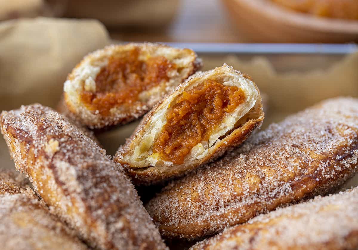 Broken in Half Pumpkin Hand Pie Showing Inside Filling. Pumpkin Hand Pies, Pumpkin Bombs, Pumpkin Desserts, Pumpkin Snacks, Pumpkin Spice, Pumpkin Crisps, Fried Pumpkin Pies, Individual Pumpkin Pies, Cinnamon Sugar Pumpkin Pies, fall recipes, Thanksgiving Recipes, Christmas Recipes, Thanksgiving Desserts, i am baker, iambaker