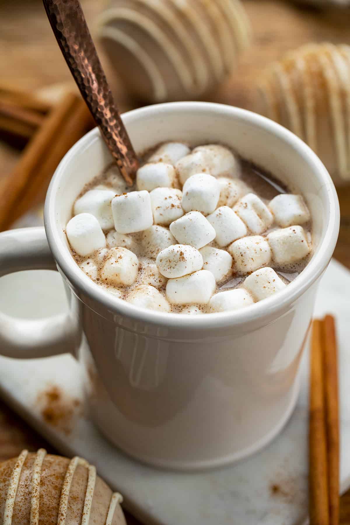 Mug Filled with Snickerdoodle Hot Cocoa Bombs and Marshmallows. Hot Chocolate Bomb, Snickerdoodle Hot Chocolate Bombs, How to Make Hot Chocolate Bombs, Best Tasting Hot Chocolate Bombs, How Long Do Hot Chocolate Bombs Last, Hot Chocolate Bombs Near Me, Easy to Make Hot Cocoa Bombs, Best Flavors for Hot Chocolate Bombs, Holiday Dessert, Christmas Chocolate Bombs, Thanksgiving Hot Chocolate Bombs, i am baker, iambaker