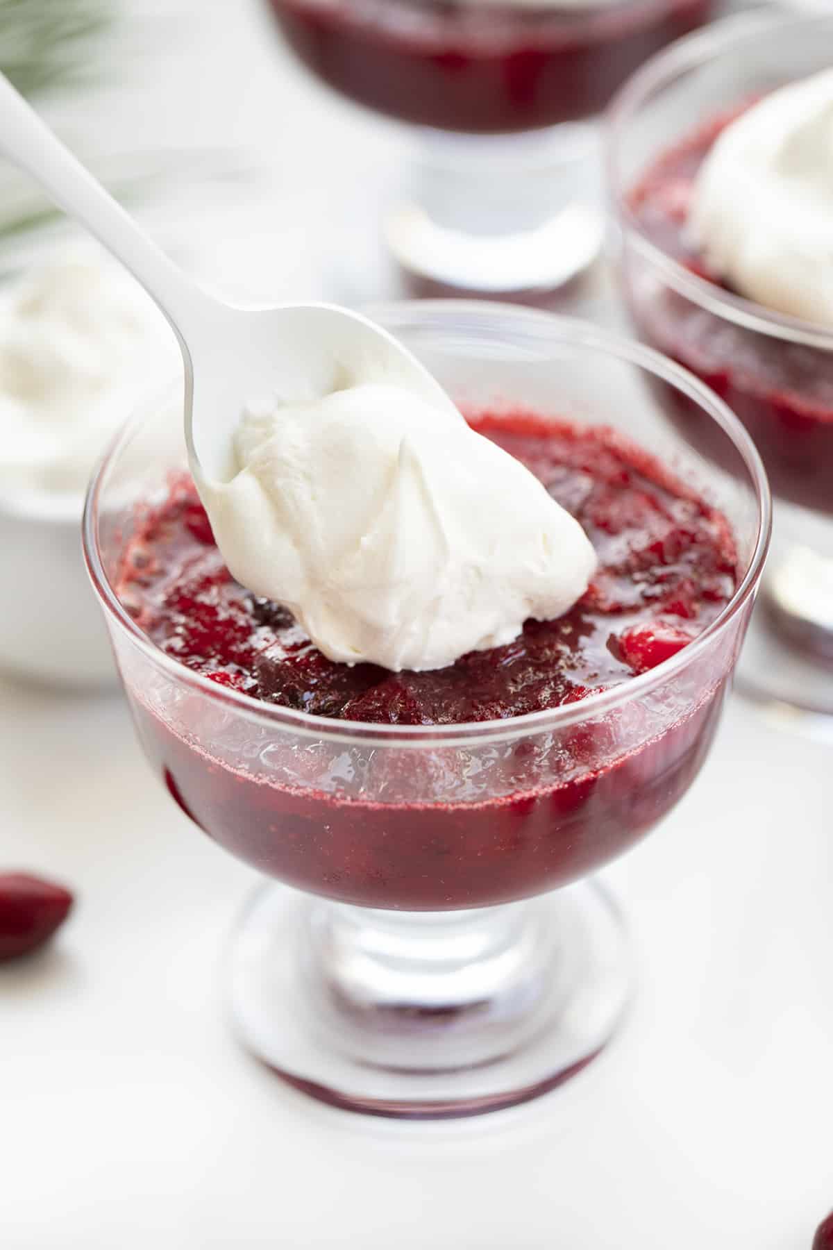 Cranberries in Snow Desserts on a White Counter with Cranberries and Pine while Creamy Whipped Topping is Added. Dessert, Holiday Dessert, Christmas Dessert, Thanksgiving Dessert, No Bake Desserts, Cream Cheese Whipped Cream, Cranberry Desserts, i am baker, iambaker