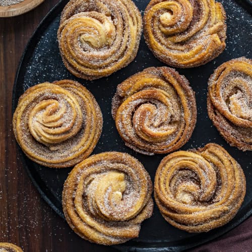 Overhead of Cruffins on a Black Serving Plate. Baking, Breakfast, Cruffins, Croissant Muffins, Easy Cruffins, Easy Cruffin Recipe, Fall Baking, Cinnamon Cruffins, Cinnamon Sugar Cruffins, Dessert, Breakfast Ideas, Brunch Recipes, i am baker, iambaker