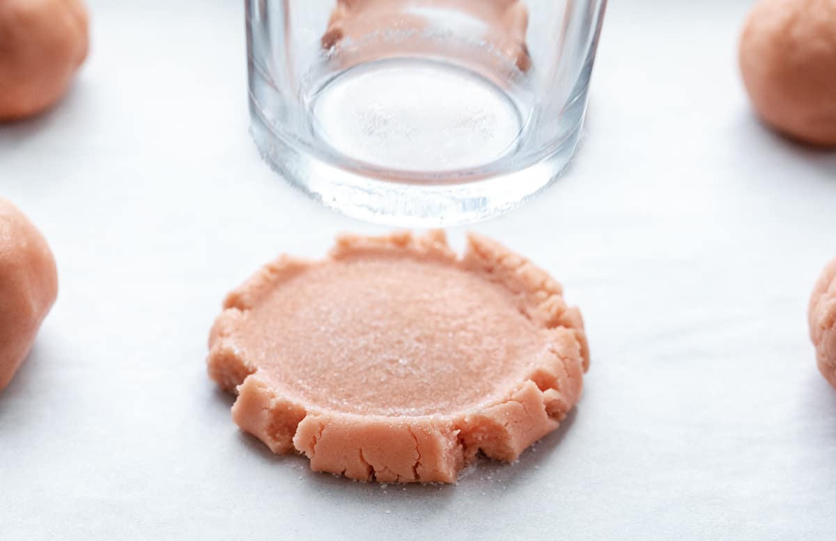 Pressing a Glass into a Pink Velvet Sugar Cookie.