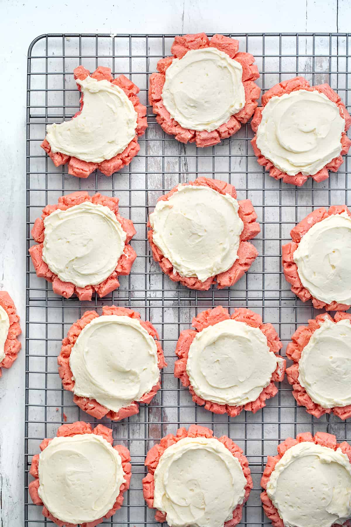 Pink Velvet Sugar Cookies with Easy Swiss Meringue on a Cooling Rack.