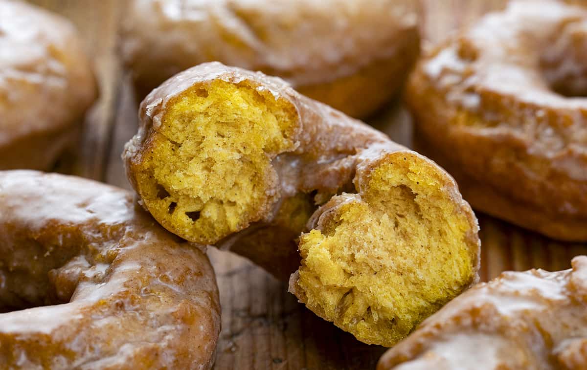 Halved Pumpkin Donut Showing Inside Yellow Color and Soft Texture. Breakfast, Donuts, Donut Recipes, Pumpkin Donut Recipes, How to Fry Donuts, Pumpkin Donuts in the Air Fryer, How to Bake Donuts, Baked Pumpkin Donuts, Brunch Ideas, Fall Baking, Best Pumpkin Donuts, i am baker, iambaker