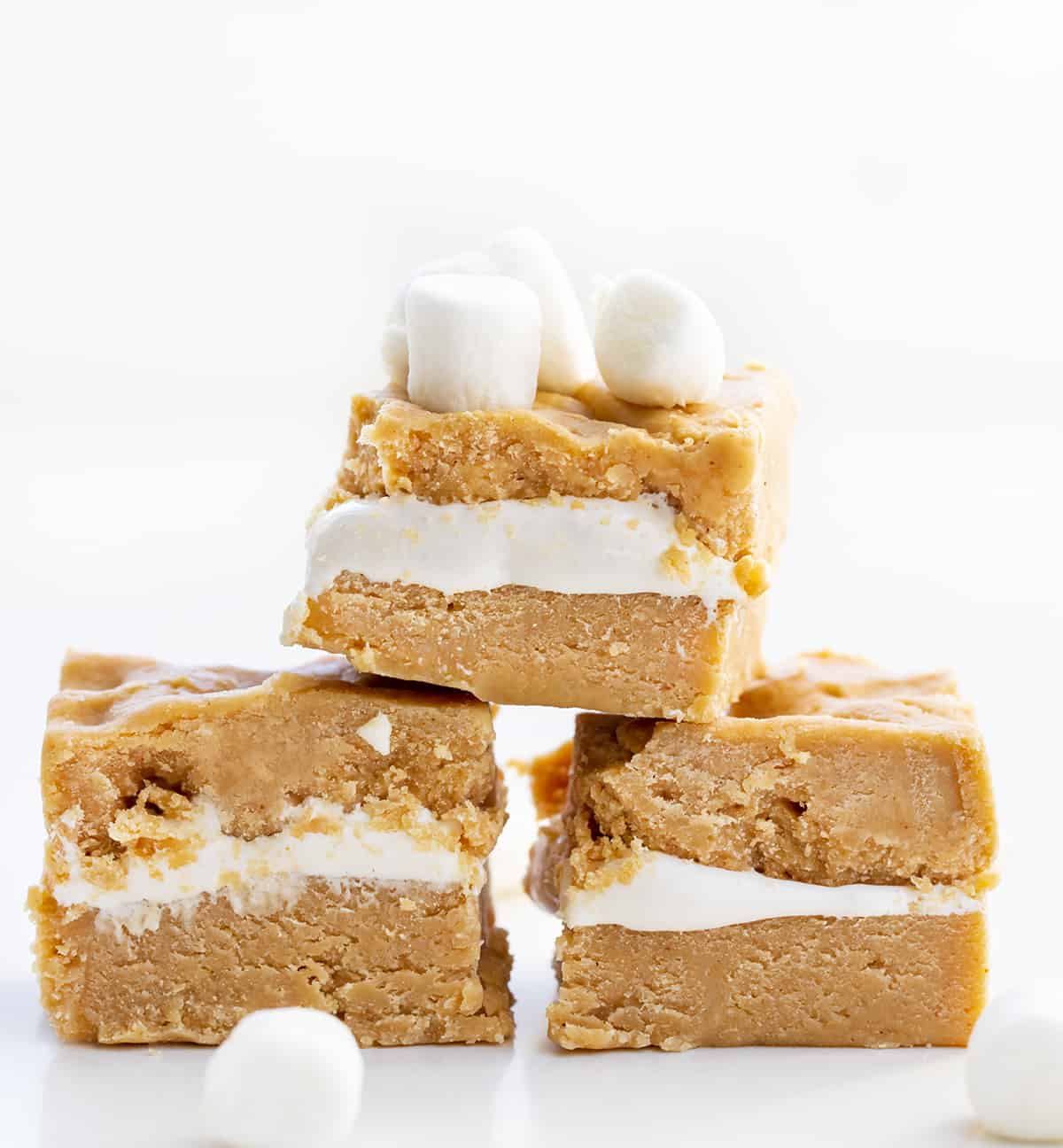 Pieces of Fluffernutter Fudge or Peanut Butter and Marshmallow Fudge Stacked in a Pyramid on a White Counter. 